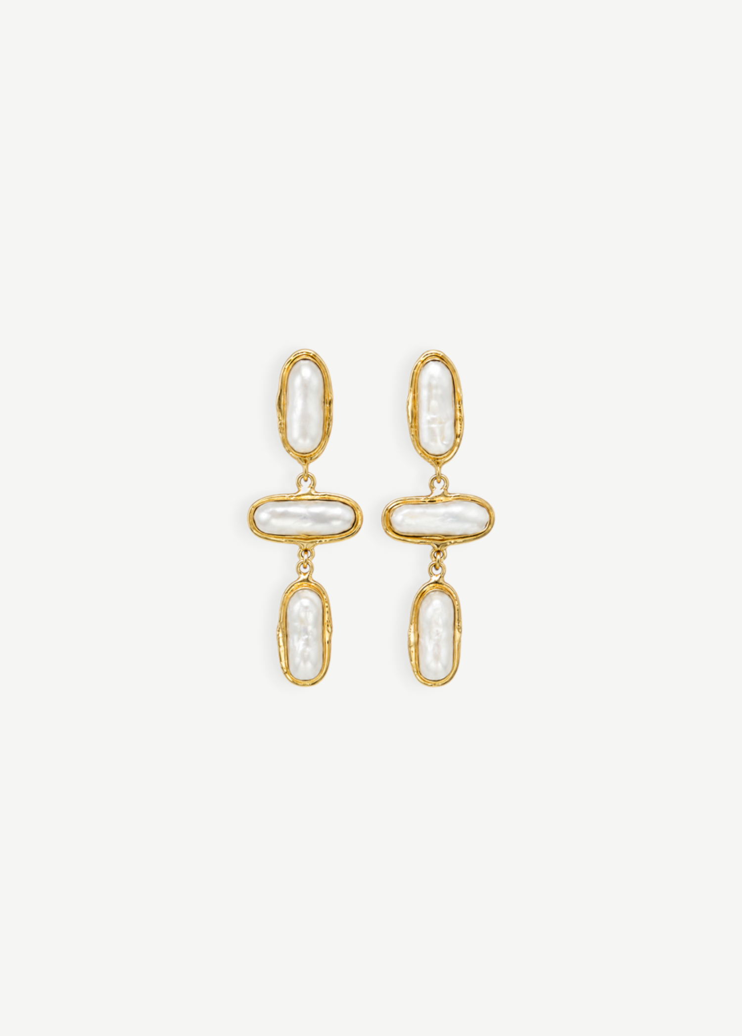 KABE SHOP INC Grace earrings featuring organic baroque pearls set in textured gold frames in a drop design.