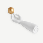 KABE SHOP INC Atlas porcelain incense holder featuring a white sculpted hand balancing a gold sphere on its fingertip.