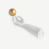 KABE SHOP INC Atlas porcelain incense holder featuring a white sculpted hand balancing a gold sphere on its fingertip.