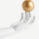 KABE SHOP INC Atlas porcelain incense holder featuring a white hand sculpture balancing a gold sphere on fingertips.