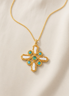 KABE SHOP INC Croix Baroque pendant necklace featuring a gold cross with white baroque pearls and turquoise stones.