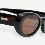 KABE SHOP INC Naomi sunglasses featuring a black oval cellulose acetate frame and brown lenses with gold logo detail