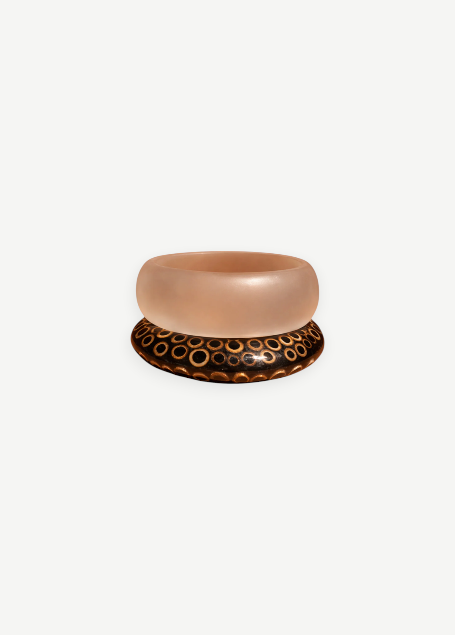 KABE SHOP INC wood and resin bangle set featuring a translucent resin band and a dark wood band with circle patterns.