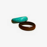 KABE SHOP INC resin bangle set featuring one turquoise crackle-patterned bracelet and one solid dark brown bracelet.