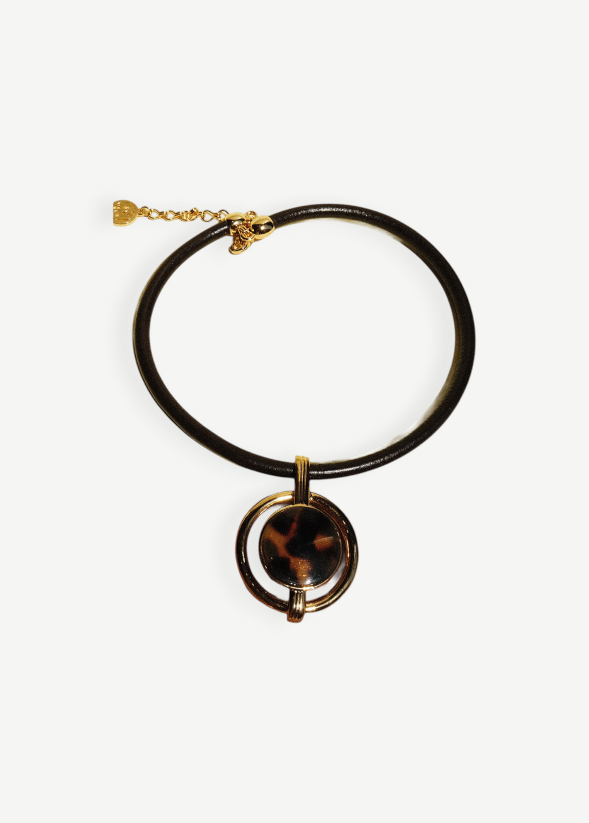 KABE SHOP INC oval pendant necklace featuring a gold-plated frame, brown cord, and a tortoiseshell-style center piece.