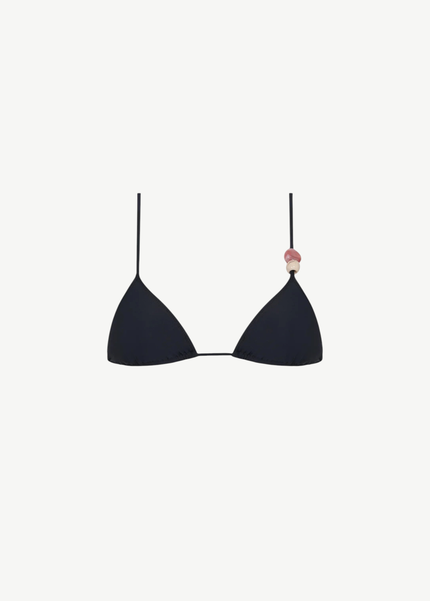 The Equator Top is a black triangle bikini top with a classic silhouette, made from eco-friendly recycled polyamide swimwear fabric. It features a pink and beige decorative bead on one strap and is shown against a plain white background.