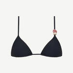 The Equator Top is a black triangle bikini top with a classic silhouette, made from eco-friendly recycled polyamide swimwear fabric. It features a pink and beige decorative bead on one strap and is shown against a plain white background.