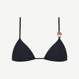The Equator Top is a black triangle bikini top with a classic silhouette, made from eco-friendly recycled polyamide swimwear fabric. It features a pink and beige decorative bead on one strap and is shown against a plain white background.