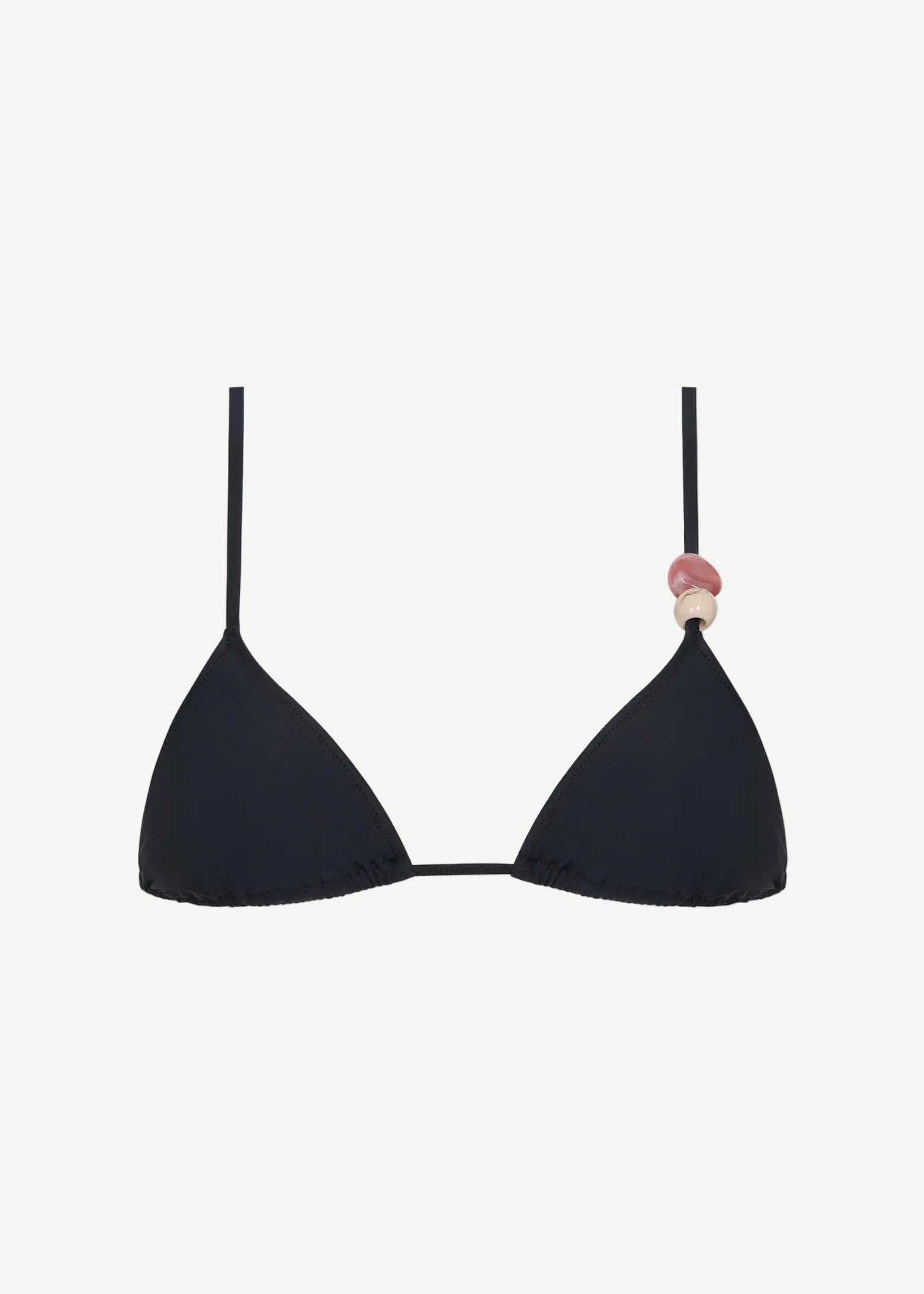 The Equator Top is a black triangle bikini top with a classic silhouette, made from eco-friendly recycled polyamide swimwear fabric. It features a pink and beige decorative bead on one strap and is shown against a plain white background.