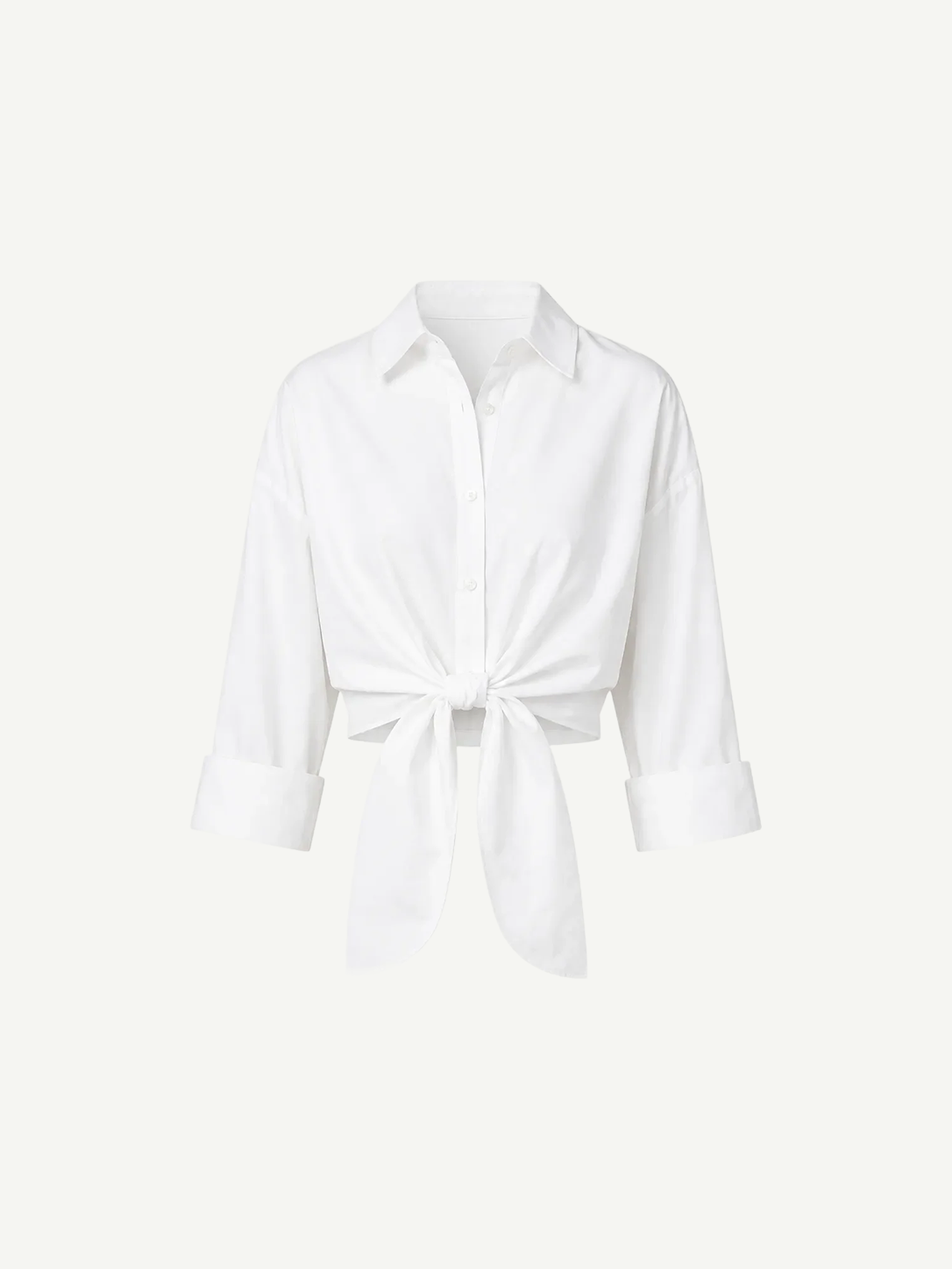 White Lisa Top featuring a collared button-down design, three-quarter length sleeves, a front tie waist, and a cropped silhouette ideal for high-waisted bottoms.