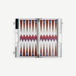 The ZigZag Backgammon Board Game features vibrant triangle patterns and comes complete with checkers stored on one side and dice in view, all beautifully crafted from acrylic and neatly presented in a sleek white carrying case—an eye-catching accent for your coffee table, photographed against a clean white background.