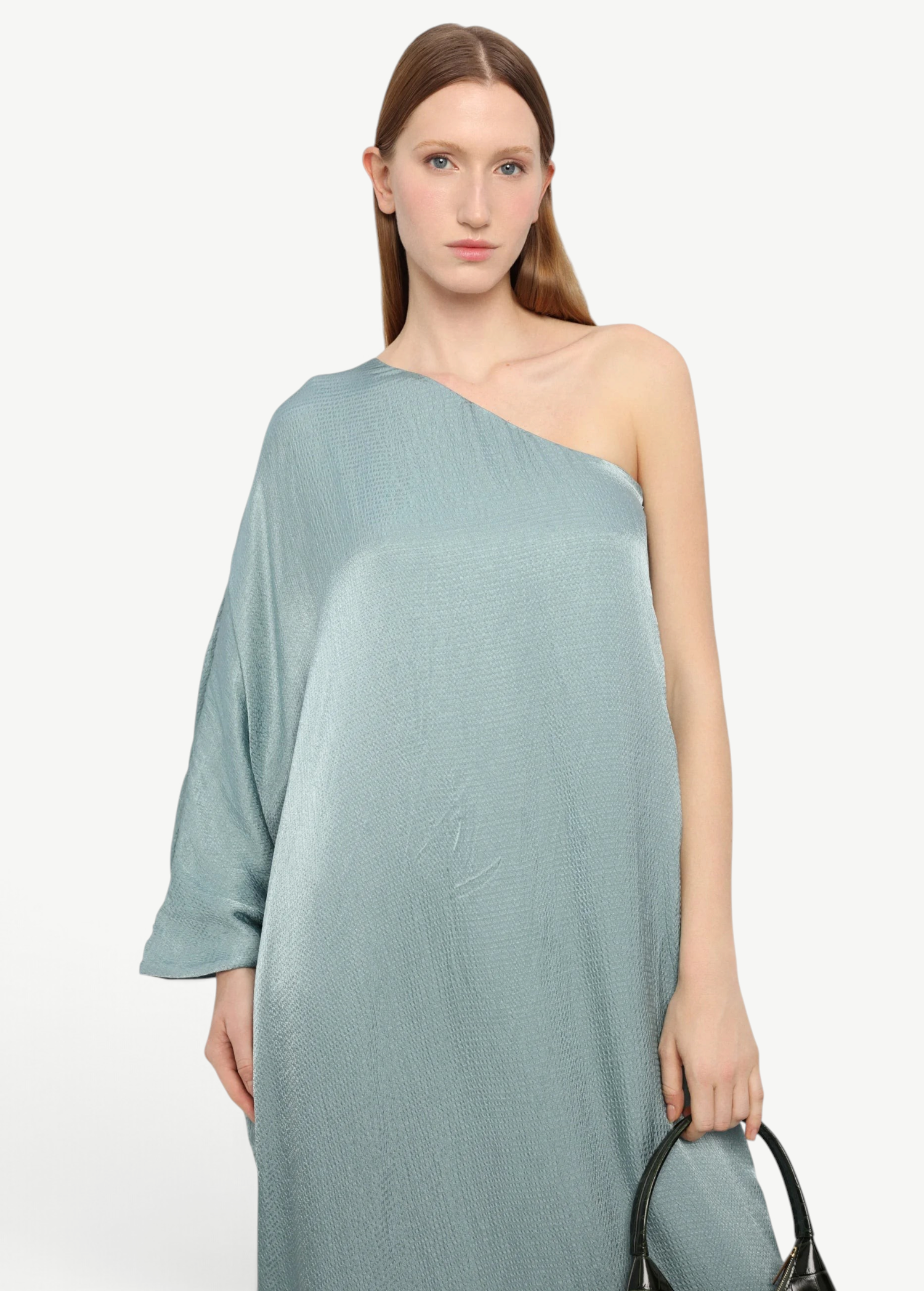 Model wearing KABE SHOP INC Sonia one-shoulder sage green maxi dress with a textured satin finish