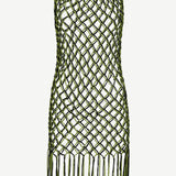 The Castaway Dress is a sleeveless macrame tunic dress crafted from green and black knotted netting with large diamond-shaped openings and long beaded fringe at the hem, handmade in Peru.