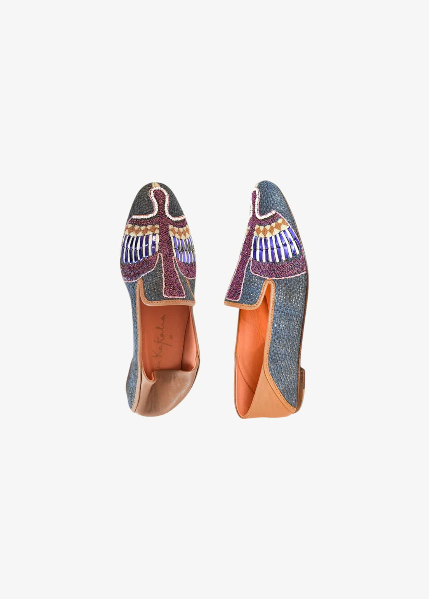 Two Anzu Moccasins featuring colorful, intricate beadwork and tan leather accents are displayed against a white background—one viewed from the top and one from the side. These hand-embroidered leather moccasins highlight vibrant craftsmanship and timeless style.