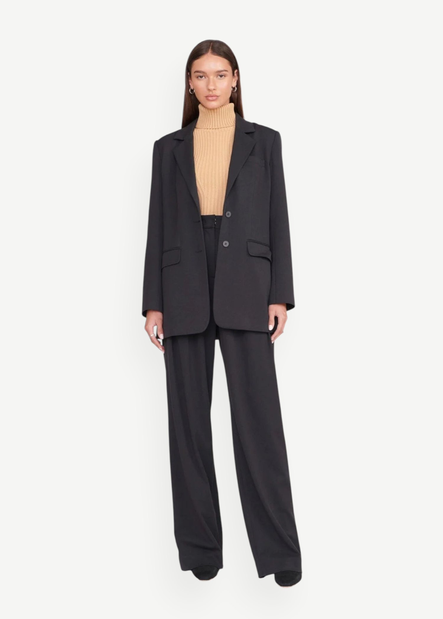 Model wearing KABE SHOP INC Luisa Pant in black with a matching blazer and beige turtleneck for a tailored look.