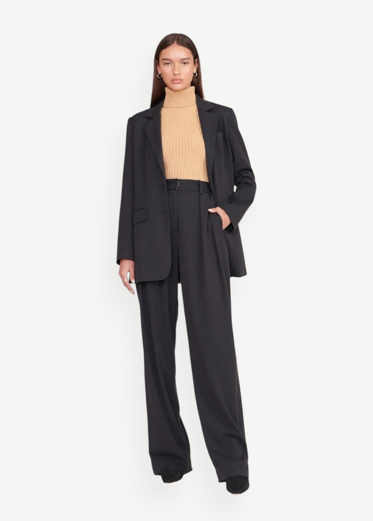 Model wearing KABE SHOP INC Luisa Pant in black with a matching blazer and beige turtleneck for a tailored look