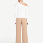 Back view of a woman wearing a white KABE SHOP INC Craftsman Sweater with an asymmetrical off-shoulder neckline.