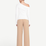 Back view of a woman wearing a white KABE SHOP INC Craftsman Sweater with an asymmetrical off-shoulder neckline.