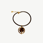 KABE SHOP INC oval pendant necklace featuring a gold-plated frame with a tortoiseshell inlay on a brown cord.