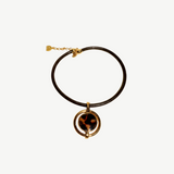 KABE SHOP INC oval pendant necklace featuring a gold-plated frame with a tortoiseshell inlay on a brown cord.