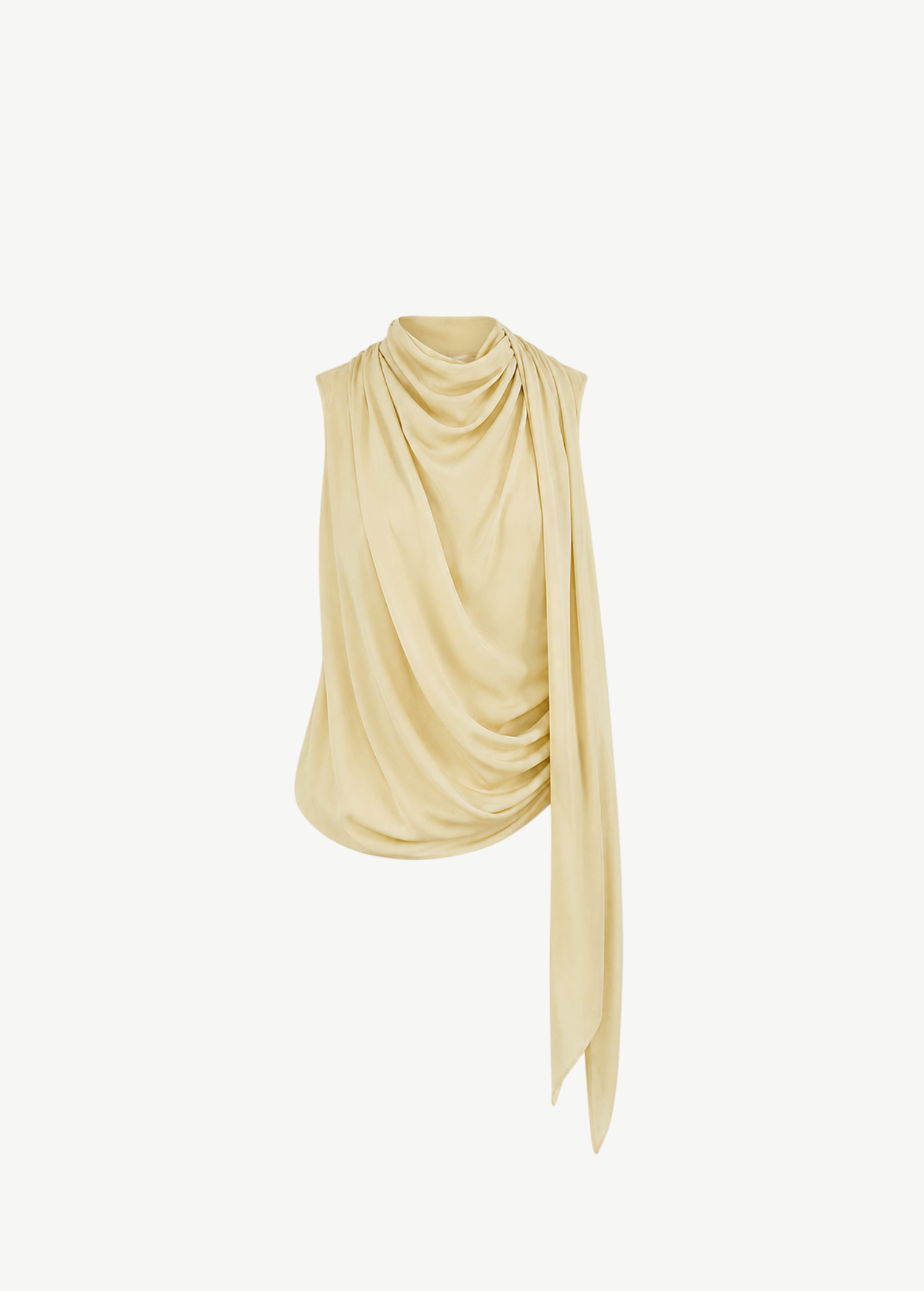 Pale yellow Menorca top with a high neckline and an asymmetric silhouette featuring draped fabric flowing down one side.