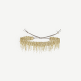A gold beaded choker necklace with fringed dangling strands, tied at the back with adjustable silver cords, is beautifully displayed against a plain white background—an ideal match for the N° 675 Gold Bracelet, creating an elegant layered look.
