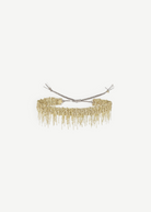 A gold beaded choker necklace with fringed dangling strands, tied at the back with adjustable silver cords, is beautifully displayed against a plain white background—an ideal match for the N° 675 Gold Bracelet, creating an elegant layered look.