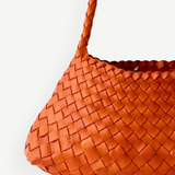 KABE SHOP INC Rosanna Bag in vibrant orange handwoven buffalo leather with a sleek shoulder strap design.
