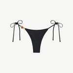 Introducing the Praia Bottom: a black bikini bottom featuring adjustable side ties and two decorative beads—one pink and one beige—on the left. Crafted from recycled polyamide, this minimal, sleek tie-bottom belongs to our eco-friendly swimwear collection, making it an ideal choice for stylish swimmers seeking sustainability.