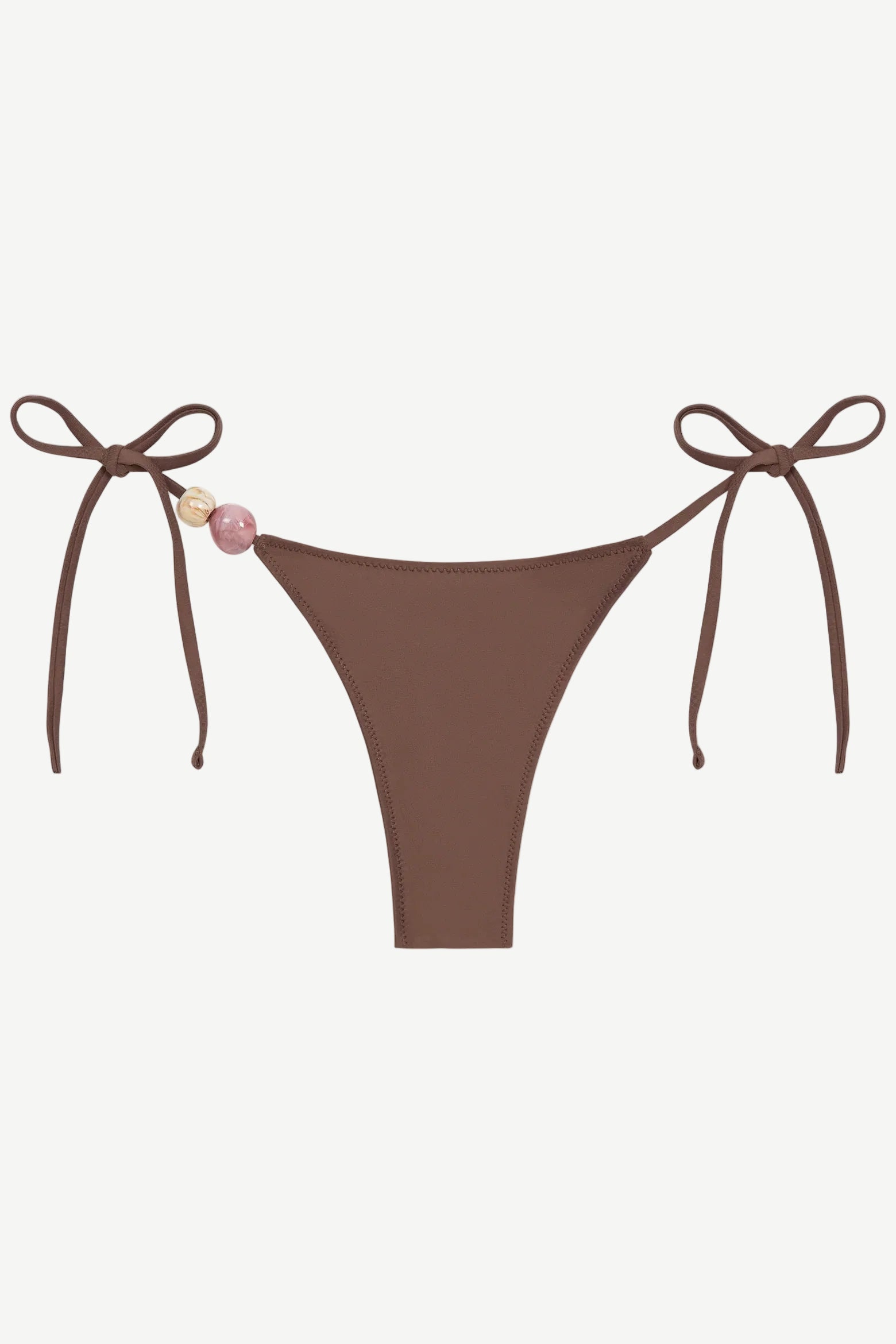 Praia Bottom in brown with adjustable tie sides, adorned with a pink and a beige bead on the left string, crafted from recycled polyamide for an eco-friendly swimwear option, shown on a white background.