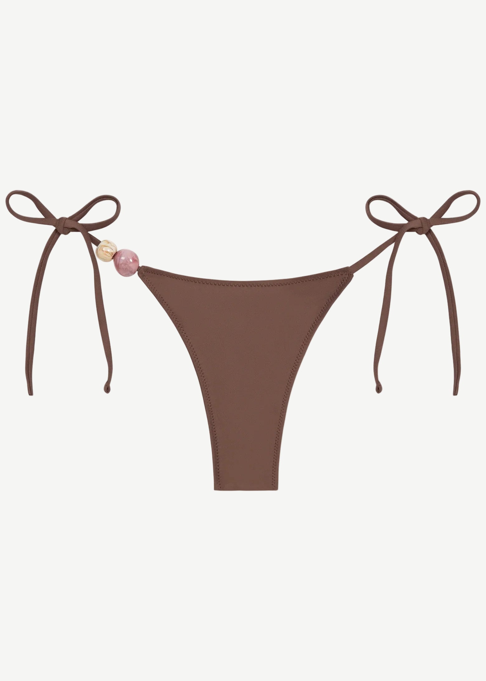 Praia Bottom in brown with adjustable tie sides, adorned with a pink and a beige bead on the left string, crafted from recycled polyamide for an eco-friendly swimwear option, shown on a white background.
