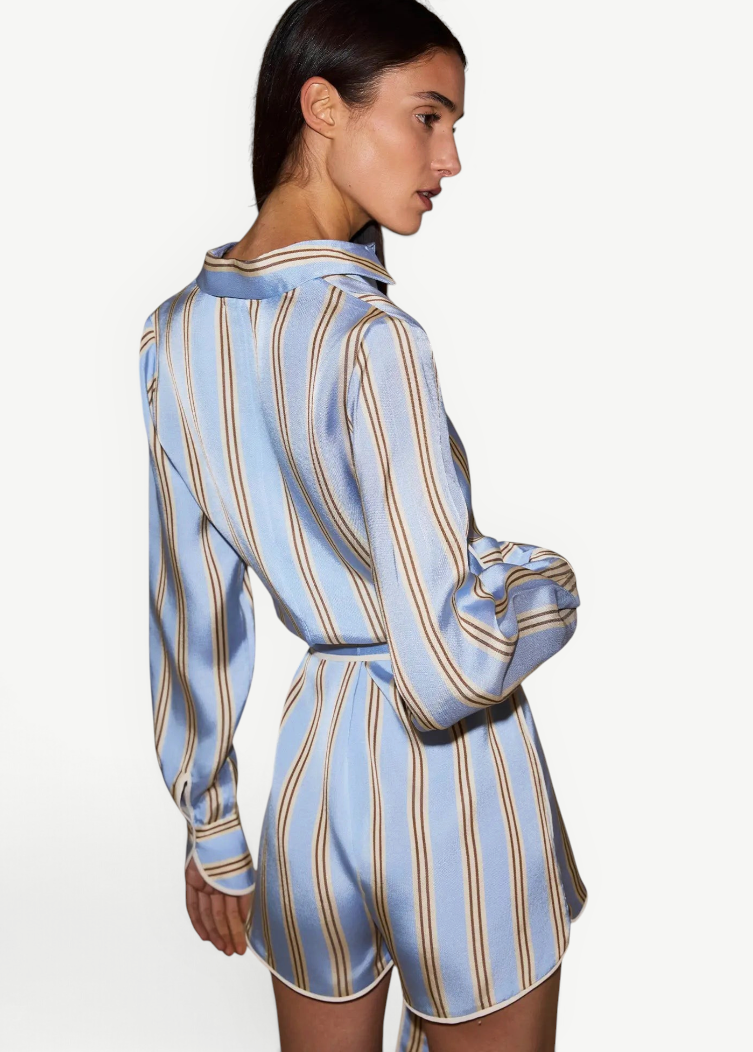 KABE SHOP INC Formentera romper in light blue with brown vertical stripes, collared neckline, and self-tie waist.