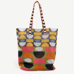 KABE SHOP INC Kanpur tote bag featuring a vibrant geometric pattern in yellow, orange, green, and black mesh fabric.