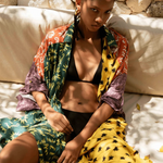 Model wearing KABE SHOP INC Estrellitas viscose shirt dress with colorful star print, wrap design, and long sleeves.