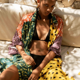Model wearing KABE SHOP INC Estrellitas viscose shirt dress with colorful star print, wrap design, and long sleeves.