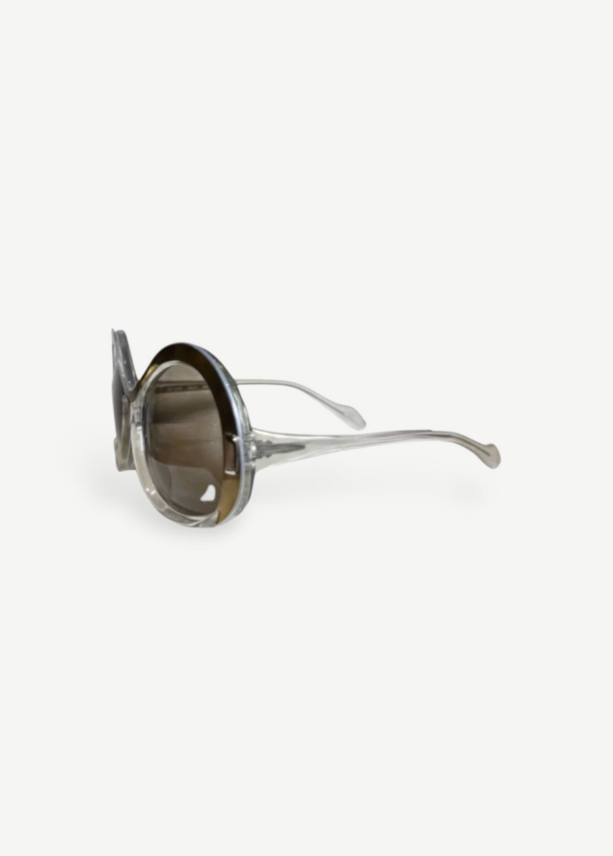 KABE SHOP INC Neostyle sunglasses featuring oversized round frames in a translucent clear finish with brown lenses.