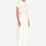 Model wearing KABE SHOP INC Grayson Pant in white with a wide-leg silhouette and a matching cream knit sweater.