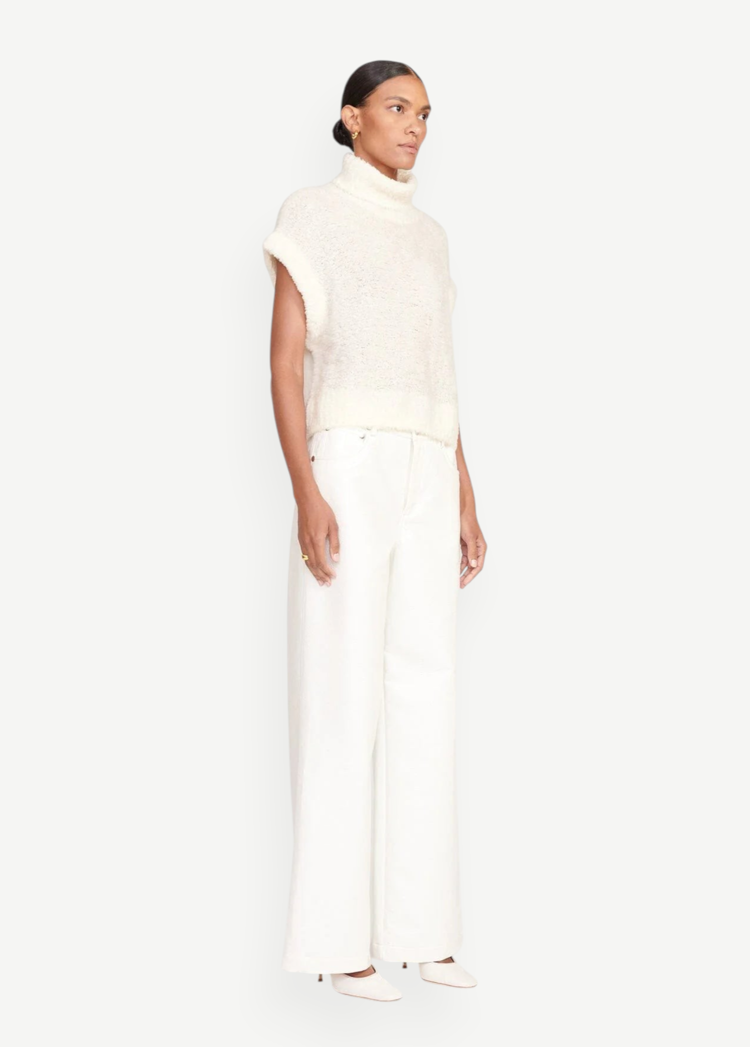 Model wearing KABE SHOP INC Grayson Pant in white with a wide-leg silhouette and a matching cream knit sweater.