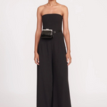 Model wearing a KABE SHOP INC Lennon convertible black bag as a waist belt with a matching black strapless jumpsuit