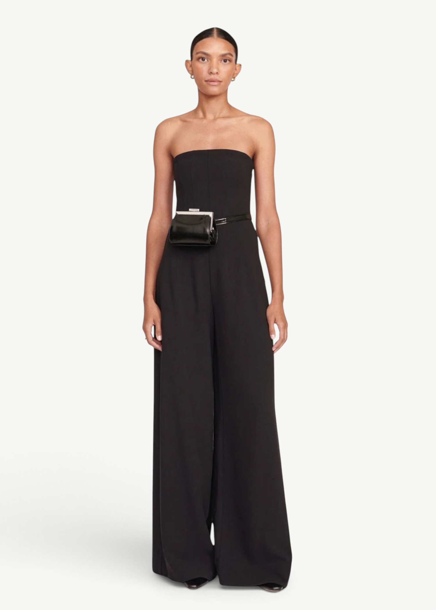 Model wearing a KABE SHOP INC Lennon convertible black bag as a waist belt with a matching black strapless jumpsuit