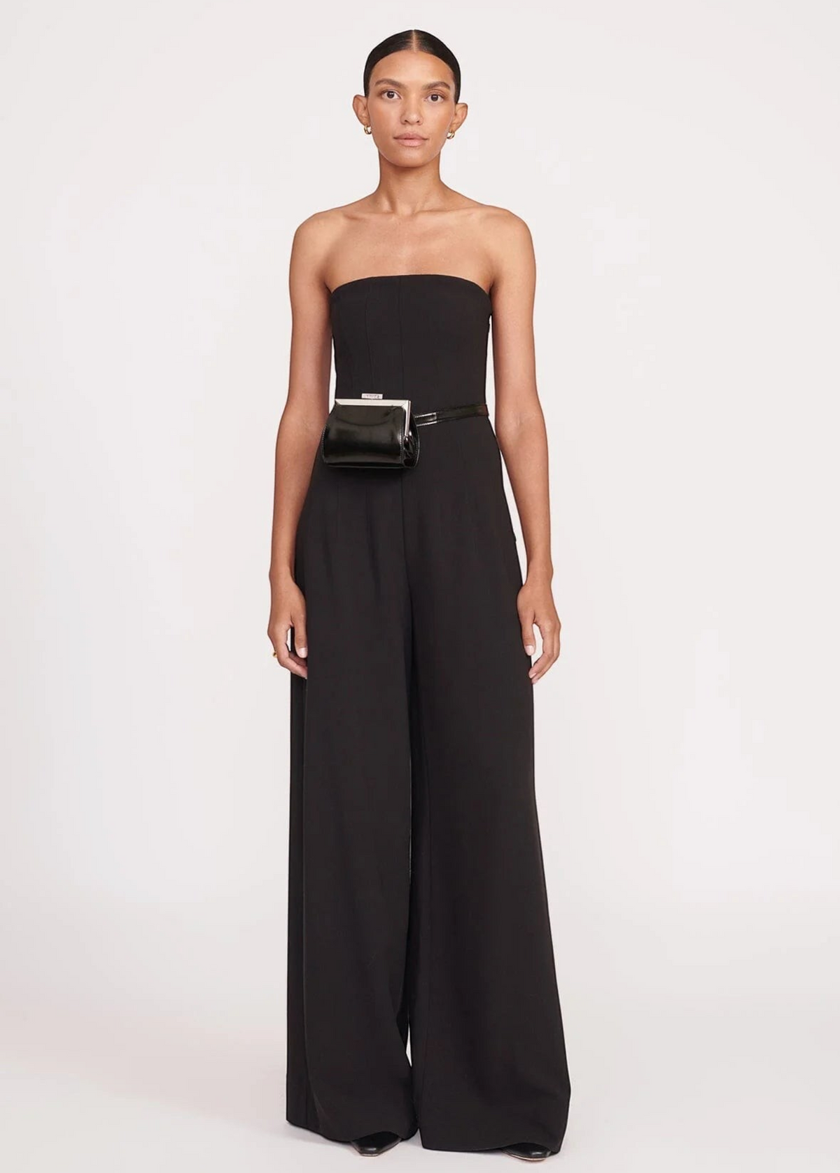 Model wearing a KABE SHOP INC Lennon convertible black bag as a waist belt with a matching black strapless jumpsuit