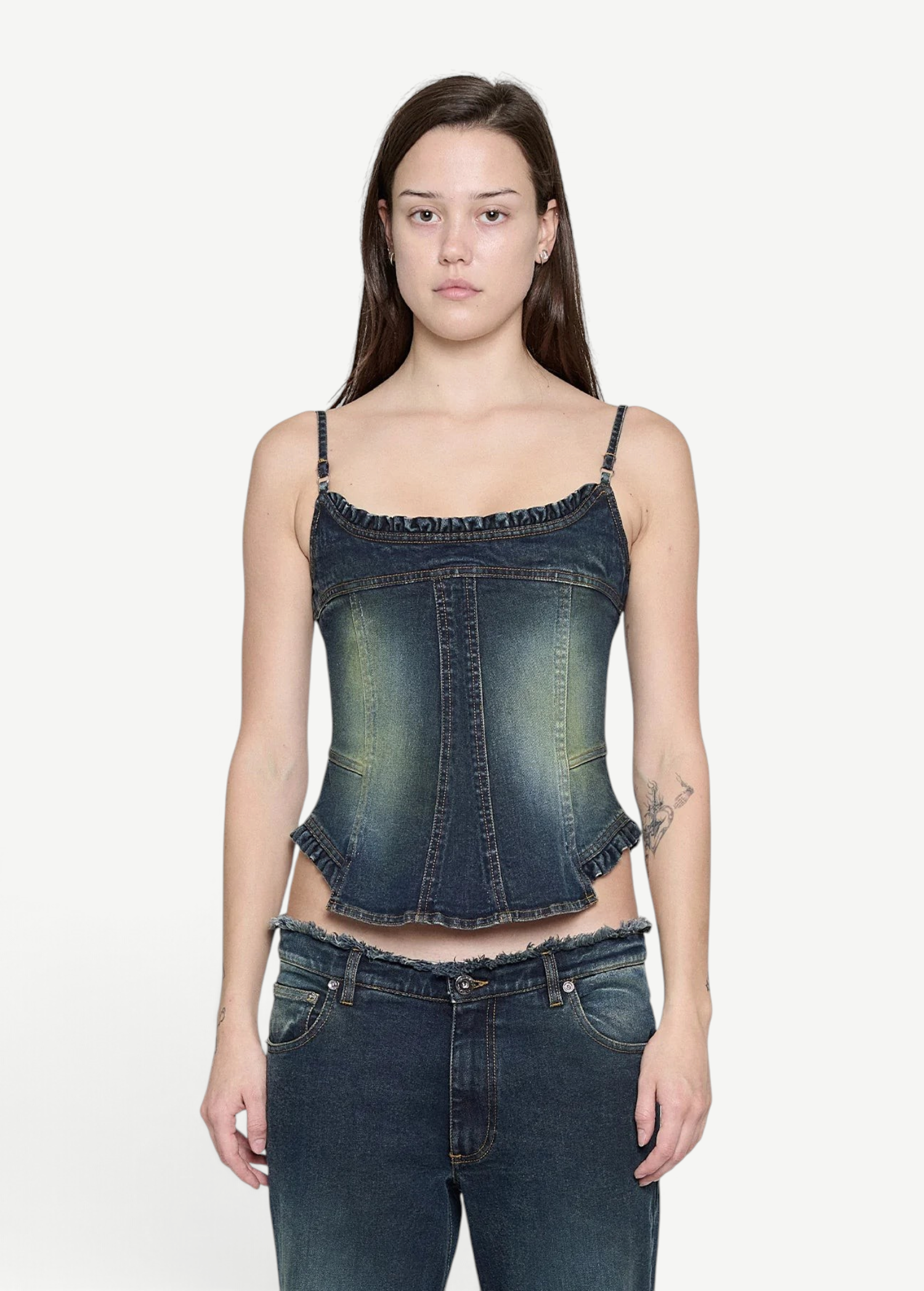 Denim Corset Top in dark wash denim with thin straps and ruffled trim along the neckline and hem, creating a sculptural silhouette.