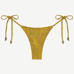 The Praia Bottom is a yellow bikini bottom with a subtle dotted pattern and adjustable side ties, each embellished with small decorative beads. Designed as eco-friendly swimwear, this piece is shown against a plain white background.