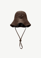 KABE SHOP INC brown woven straw hat bag with a wide brim and adjustable chin strap in a contemporary design