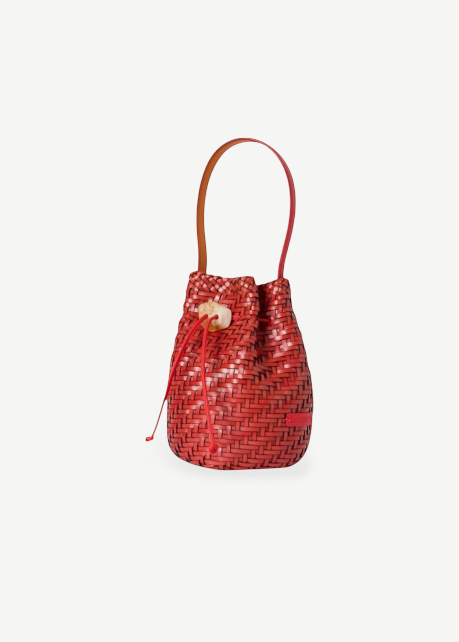 KABE SHOP INC Nirmala bucket bag in red woven leather with a sculptural stone toggle closure and slim handle.
