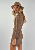Model wearing a KABE SHOP INC long-sleeve brown crochet mini dress and a matching fedora hat against a white background