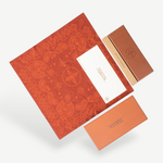 KABE SHOP INC Annie-O rose gold glasses packaging with a patterned red cloth, branded box, and warranty card.