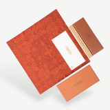 KABE SHOP INC Annie-O rose gold glasses packaging with a patterned red cloth, branded box, and warranty card.