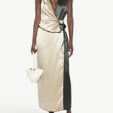 Model wearing KABE SHOP INC Aisling top in champagne and black satin with a wrap-style silhouette and contrast trim.