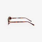 KABE Ambra oval sunglasses with a tortoiseshell frame, slim temples, and gold-tone logo lettering side view